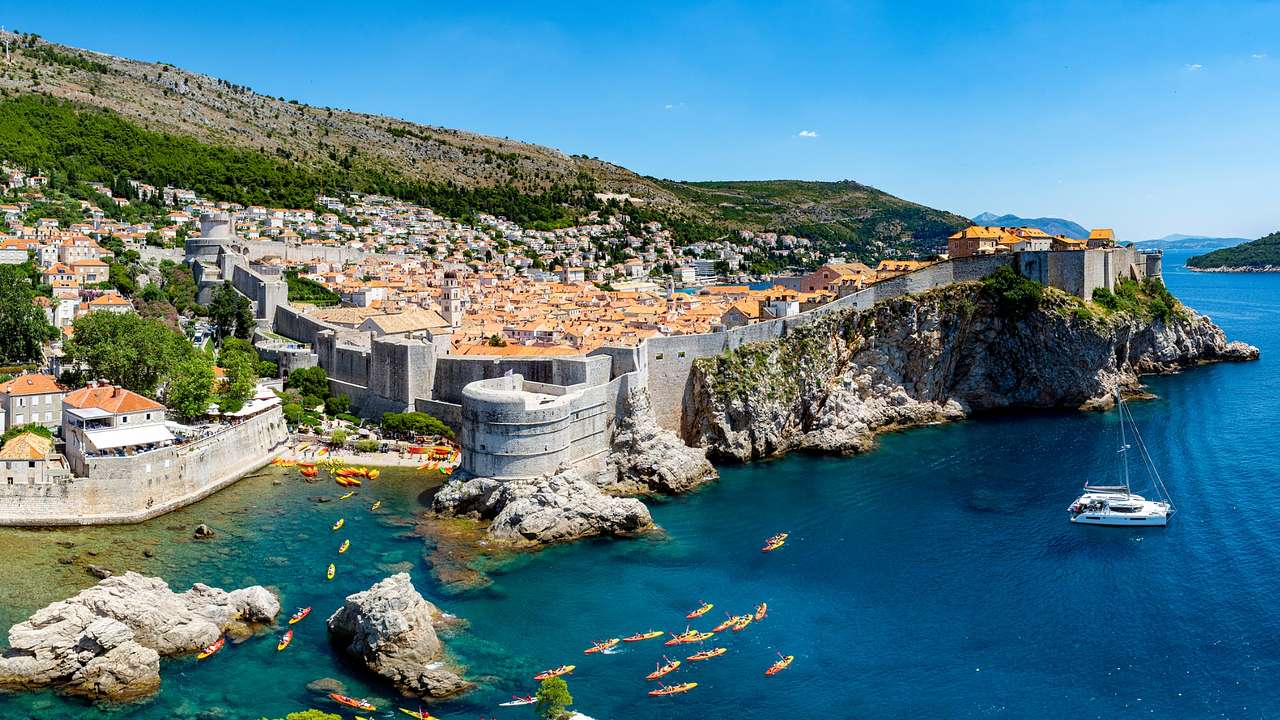 A coastal walled city built on a cliff next to the water