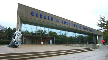 A museum with a "Gerald R. Ford Presidential Museum" sign next to a spaceman statue