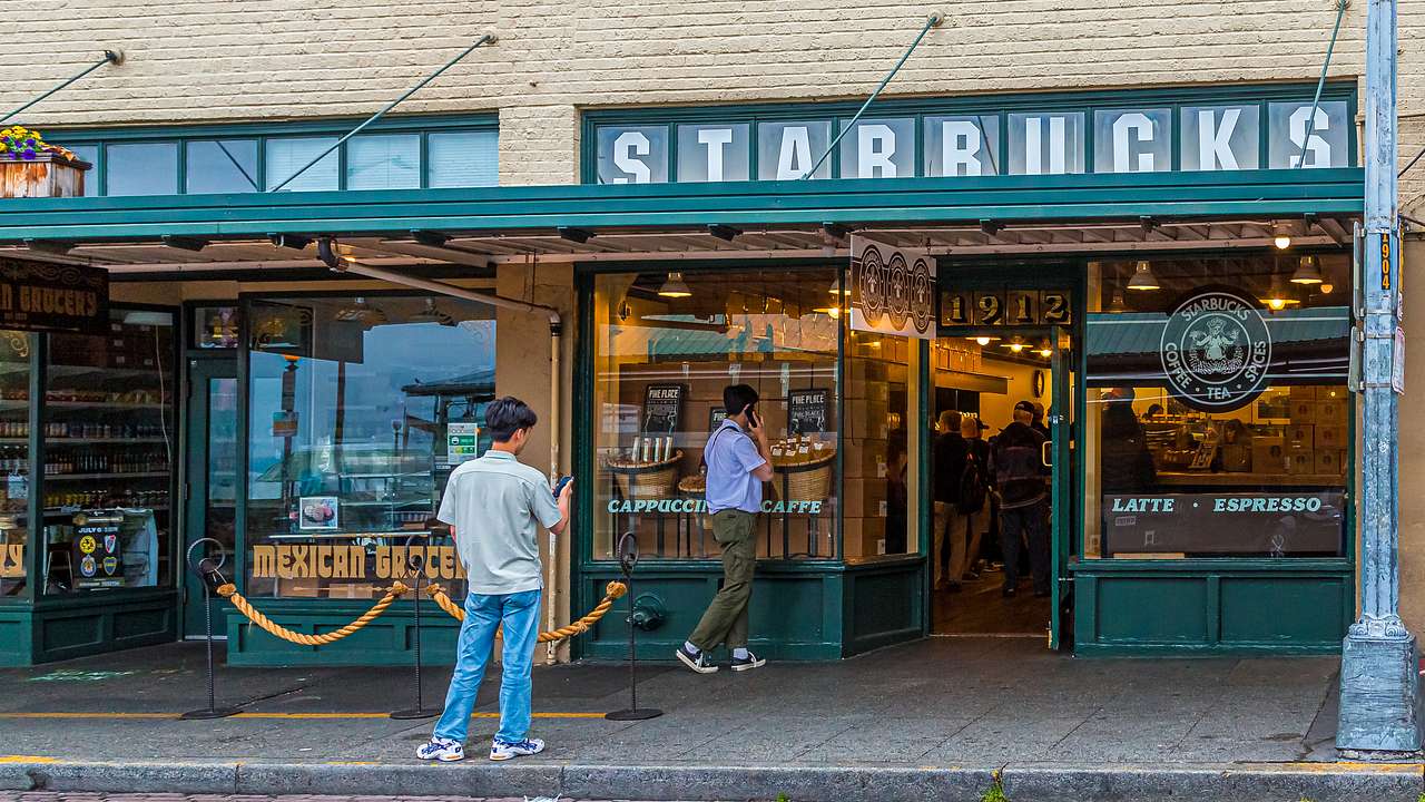 People standing outside a store with a sign saying 'Starbucks'