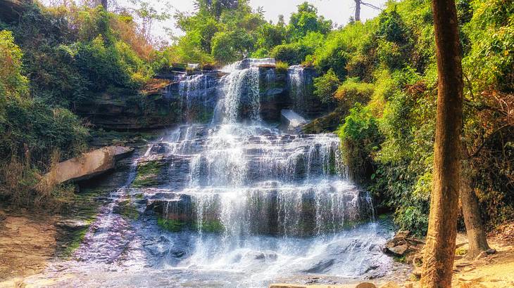 A cascading waterfall among lush greenery in Ghana