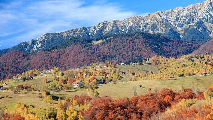 A view of the sky with a rocky mountain and a valley below from a national park