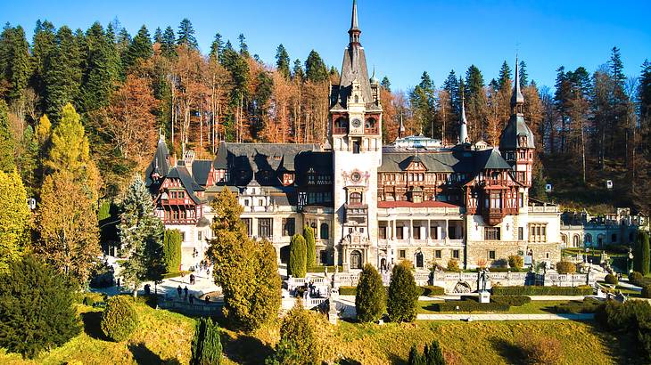 A view of a beautiful castle amongst trees, Peles Castle, Sinaia, Romania