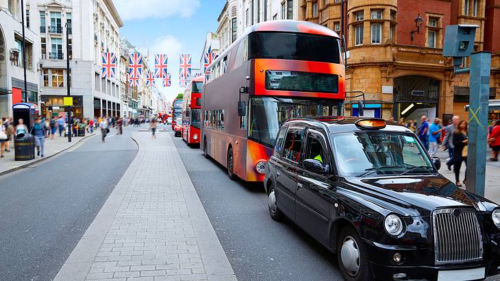 Black London Taxi and buses on Oxford Shopping Street, London, UK