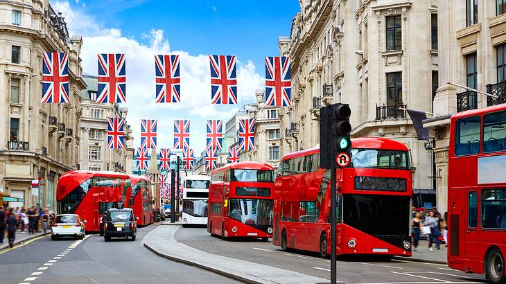 London's Regent Street with hanging British flags and red double-decker busses