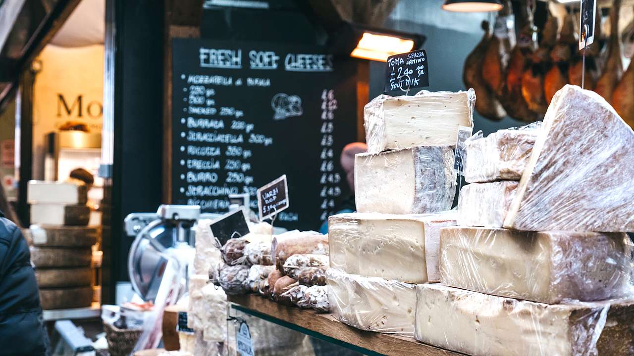 Variety of cheeses and food on display at Borough Market in London, UK