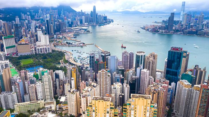 Aerial view of city buildings facing a body of water, Hong Kong