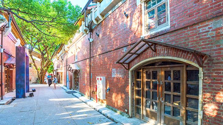 An alley with red brick buildings on both sides in the Creative Park in Taipei