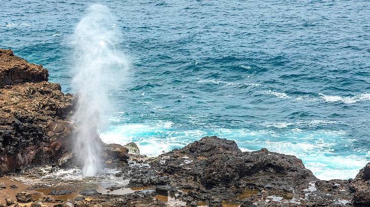 Water spouting up through a hole, Nakalele Blowhole, Maui, Hawaii, USA