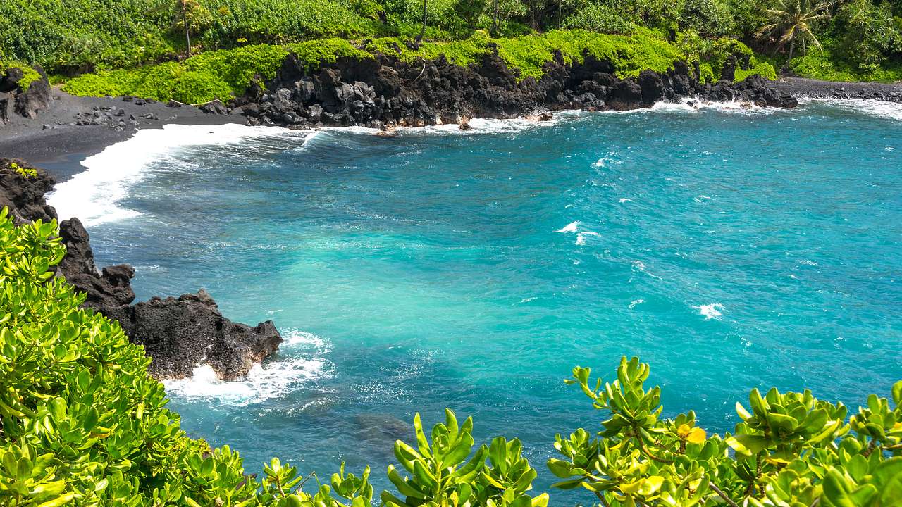 Very blue water and green trees at Waianapanapa State Park, Maui