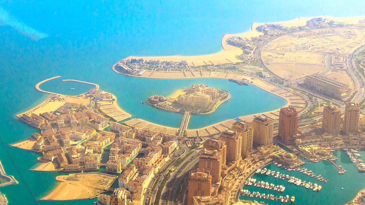 Aerial view of a luxurious and modern artificial island full of buildings and water