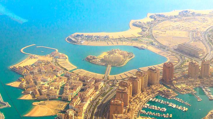 Aerial view of a luxurious and modern artificial island full of buildings and water