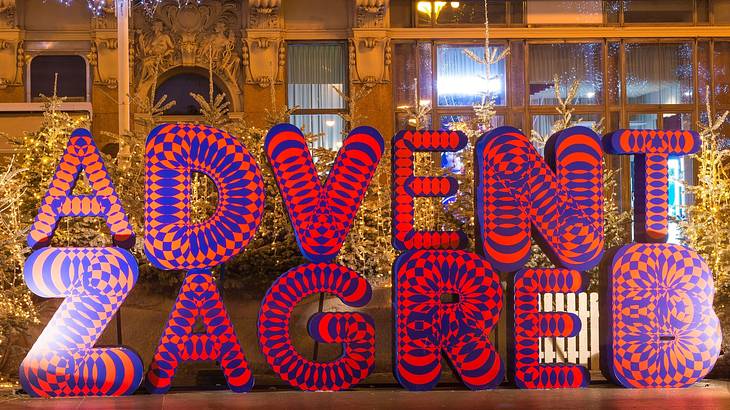 Large pink and purple letters that say "Advent Zagreb"