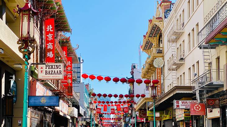 A street with buildings along it and Chinese signs and decorations
