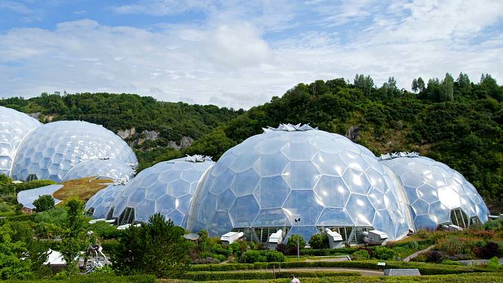 Big white domes surrounded by green hills and trees all around