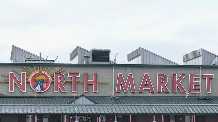 A "North Market" sign with a rooster on a building on an overcast day