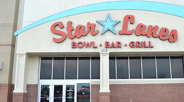 The front of a bowling alley with a "Star Lanes, Bowl, Bar, Grill" sign