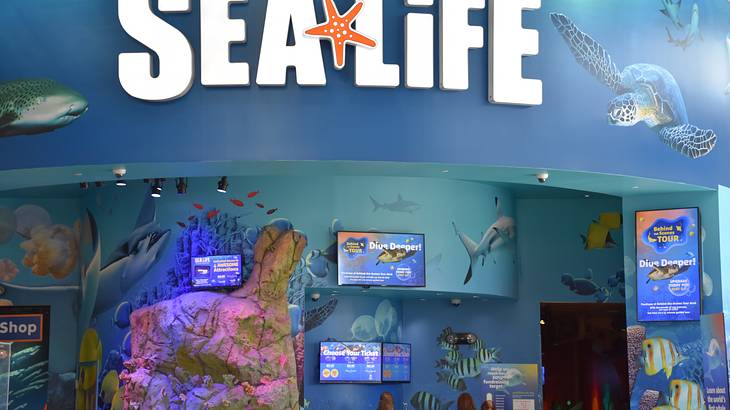 "Sea Life" signage over the admission counter with posters and ticket prices