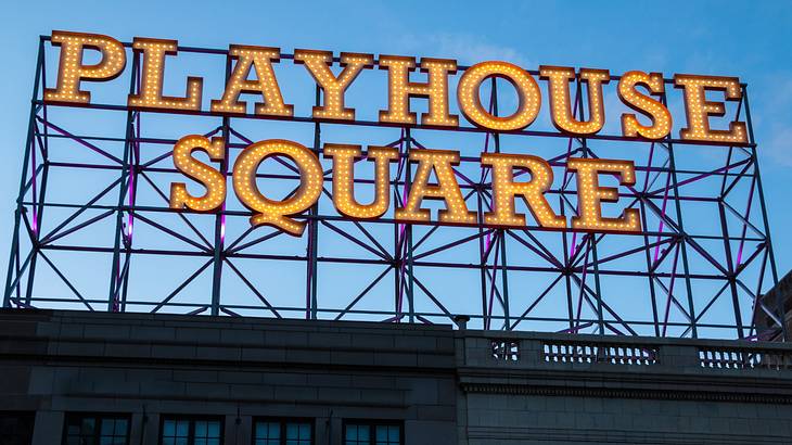 A sign that says "Playhouse Square" on a building at dusk A sign that says "Playhouse Square" on a building at dusk
