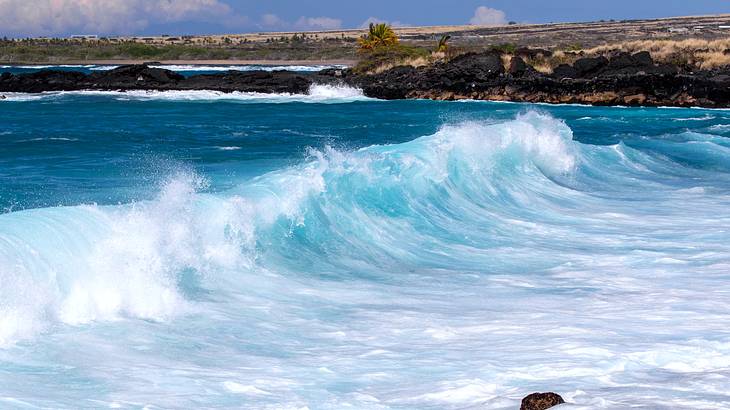 Big waves heading towards a rocky beach