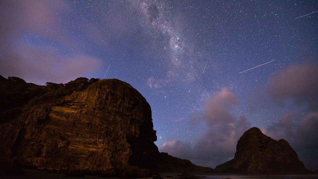 A beautiful starry night sky with a rocky landscape