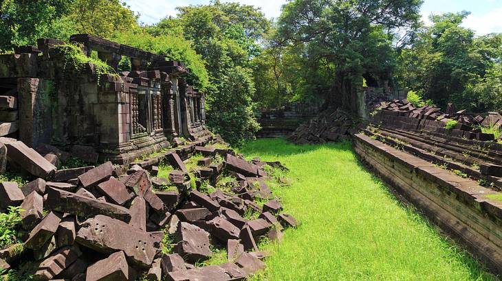 Temple ruins on the left and right with green trees behind on a nice day