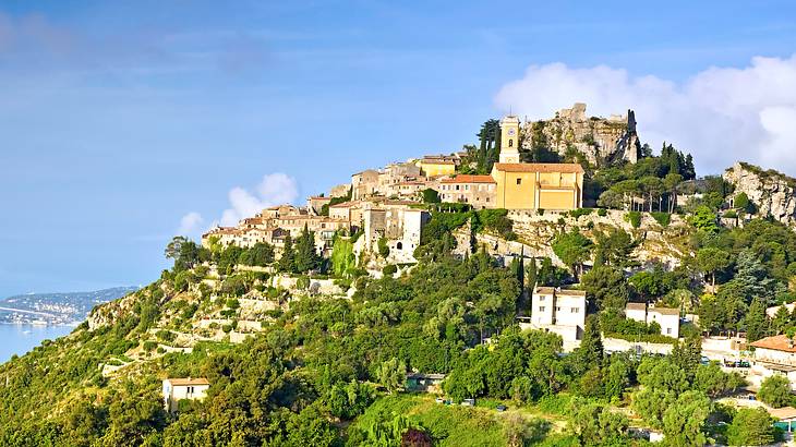 A view of the French village, Eze, on a hill full of green nature and houses