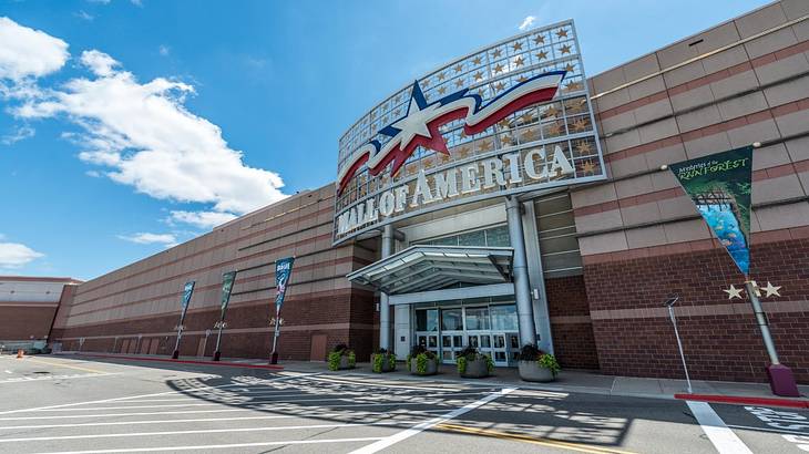 The exterior of a mall with a large "Mall of America" sign with a red and blue star The exterior of a mall with a large "Mall of America" sign with a red and blue star