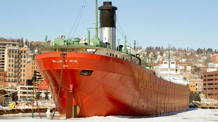 A large red ship with white text that says "William A Irvin"