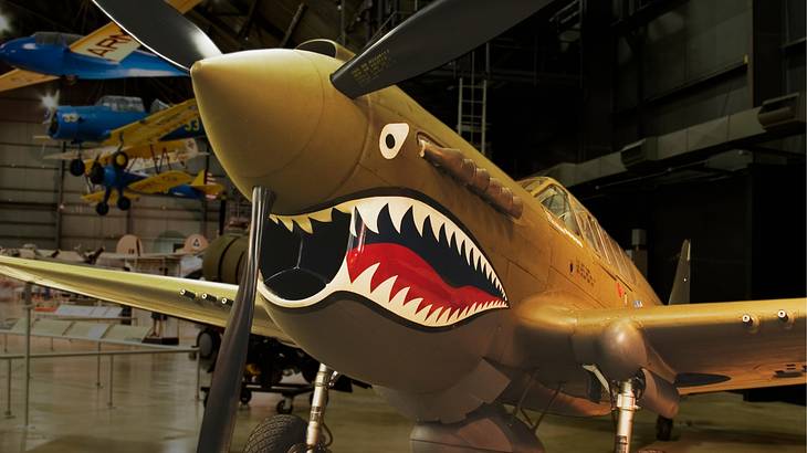 Shark's teeth design on a combat aircraft parked in a museum building
