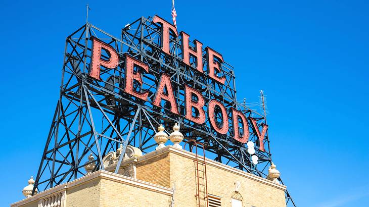A brick building with a large sign that says "The Peabody" A brick building with a large sign that says "The Peabody"