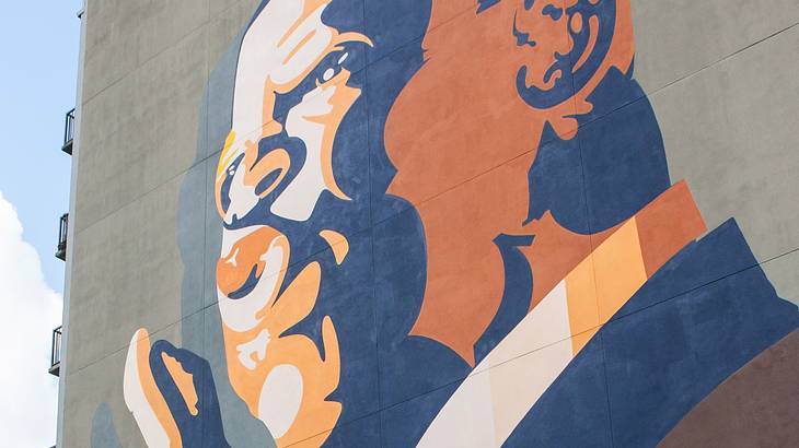 A mural of a man painted on a six-floor building