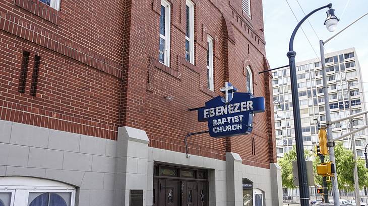 A red brick building with a blue sign that says "Ebenezer Baptist Church"