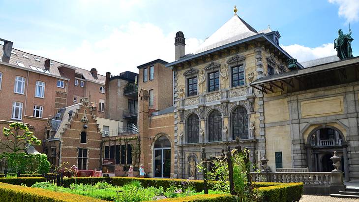 A villa-style building with a courtyard in front under a blue sky