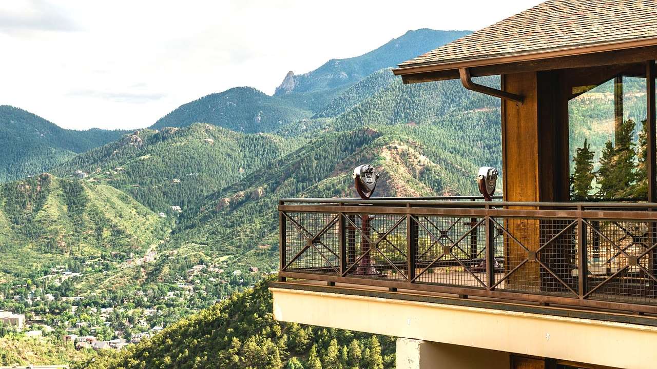 A lookout with views across a greenery-covered mountainous landscape