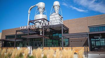 The front of an industrial building with a sign that says "Sawmill Market"