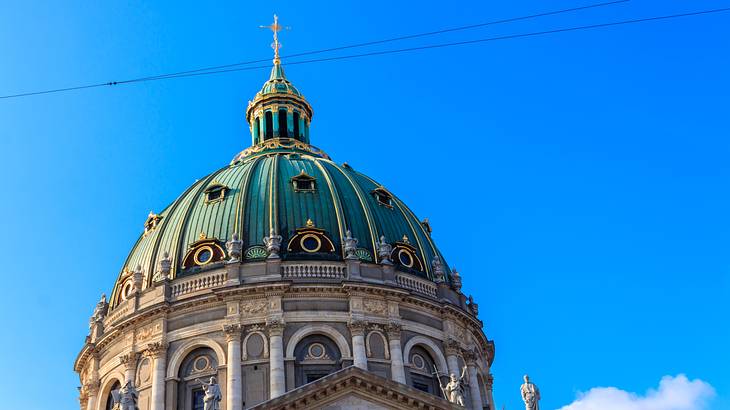 A large dome structure next to a blue sky