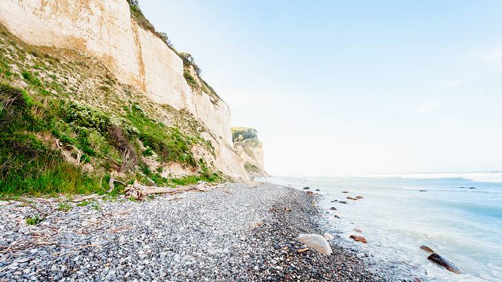 A white cliff by the shore and a body of water