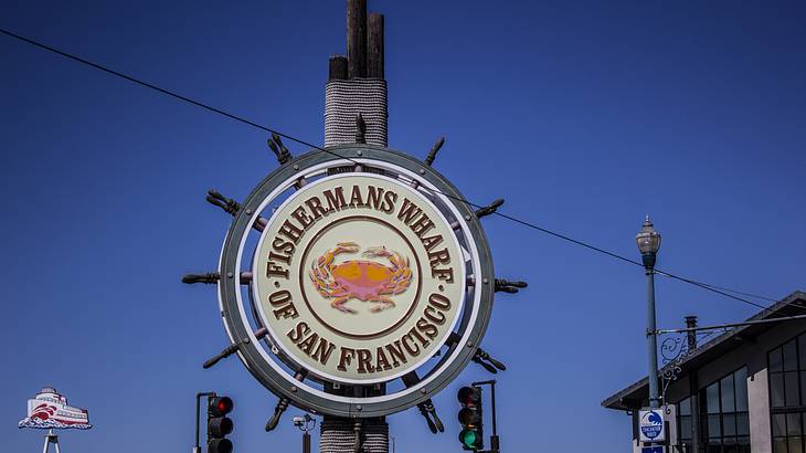 A ship's wheel sign that says "Fisherman's Wharf of San Francisco"