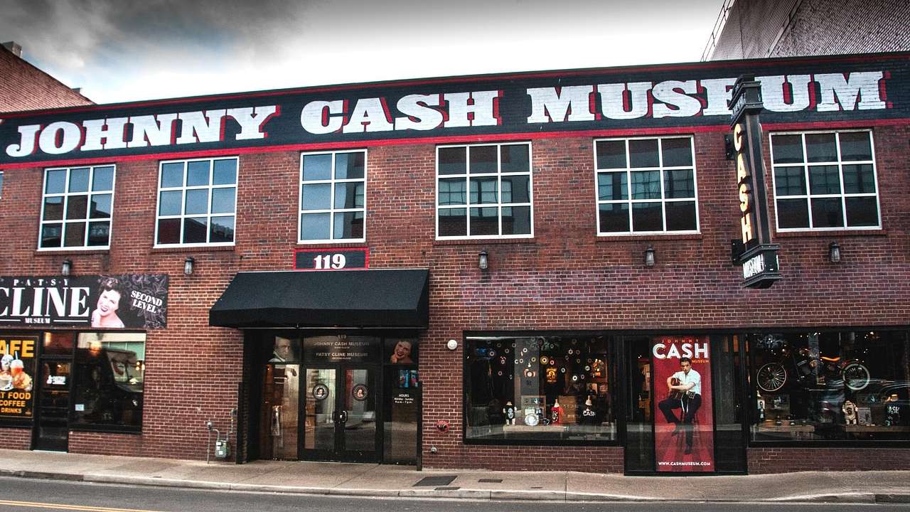 A red brick building with black awning and a "Johnny Cash Museum" sign