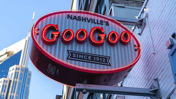 An oval-shaped sign with red neon text that says "Nashville's Goo Goo since 1912"