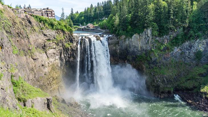 A waterfall flowing into a pool with cliffs and trees around it A waterfall flowing into a pool with cliffs and trees around it