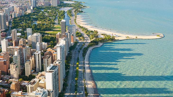 An aerial view of a city skyline with a beach to the side