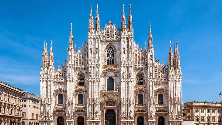 Gothic-style façade of the Milan Cathedral on a bright sunny day