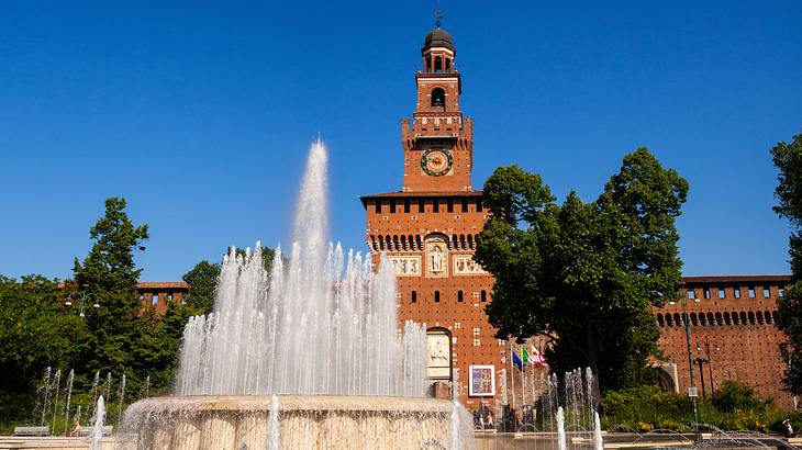 Water spraying beautifully out of a fountain in front of the Sforzesco Castle