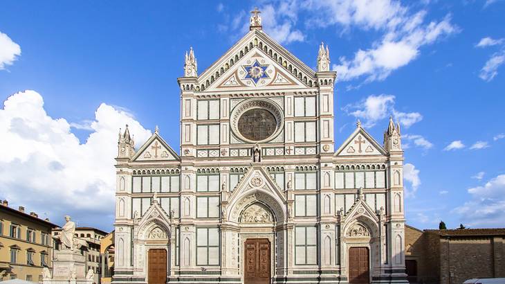Basilica di Santa Croce's façade with a statue on the right side