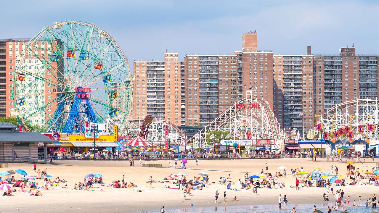 A colorful amusement park next to a beach