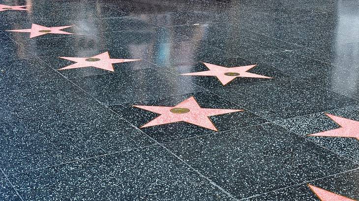 Pink stars on a dark grey tiled floor