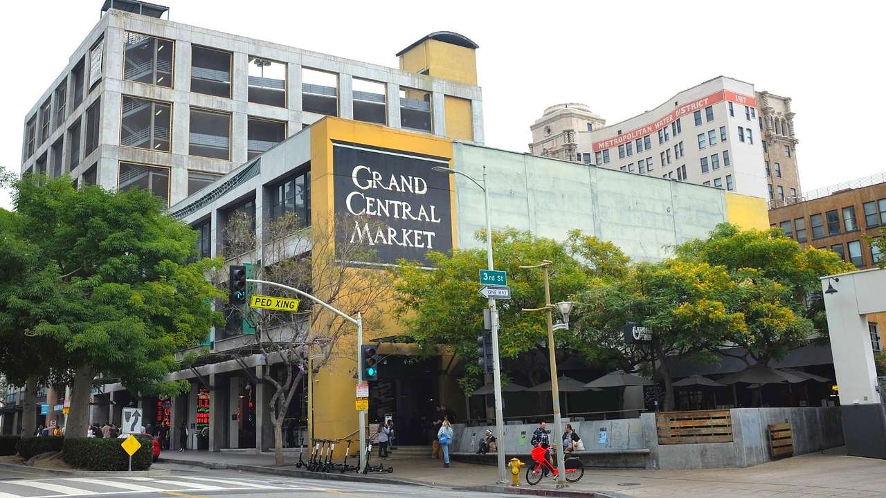 A building with a "Grand Central Market" sign and a street in front of it