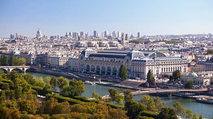 Aerial view of Musée d’Orsay surrounded by a river, trees and buildings