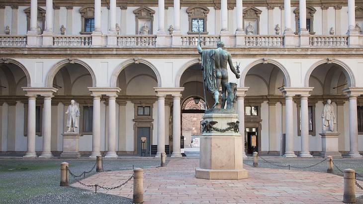 View of a courtyard in a museum with a statue in the middle